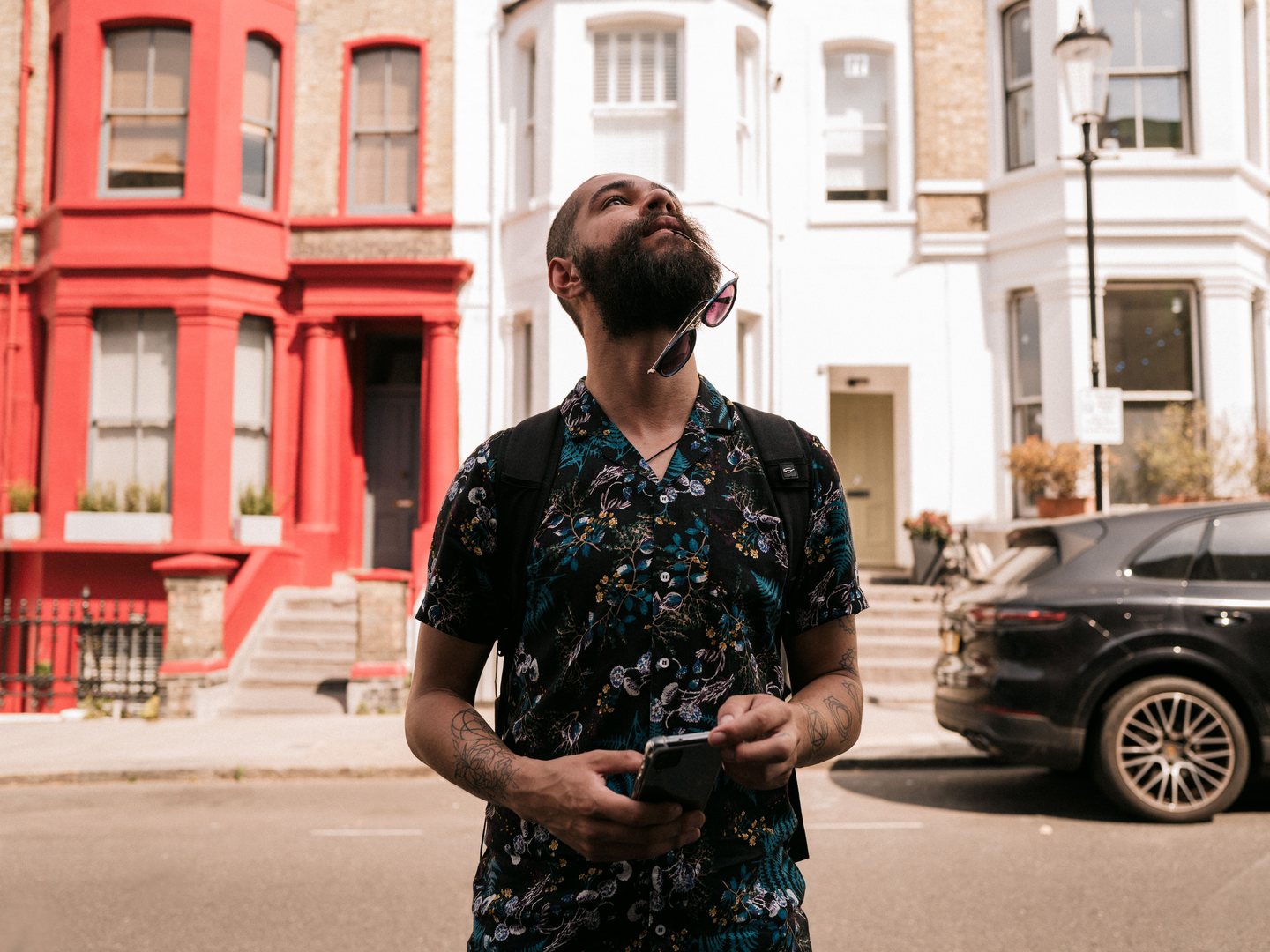 A traveler pauses on an urban city street with a smartphone, checking directions and available mobile networks.