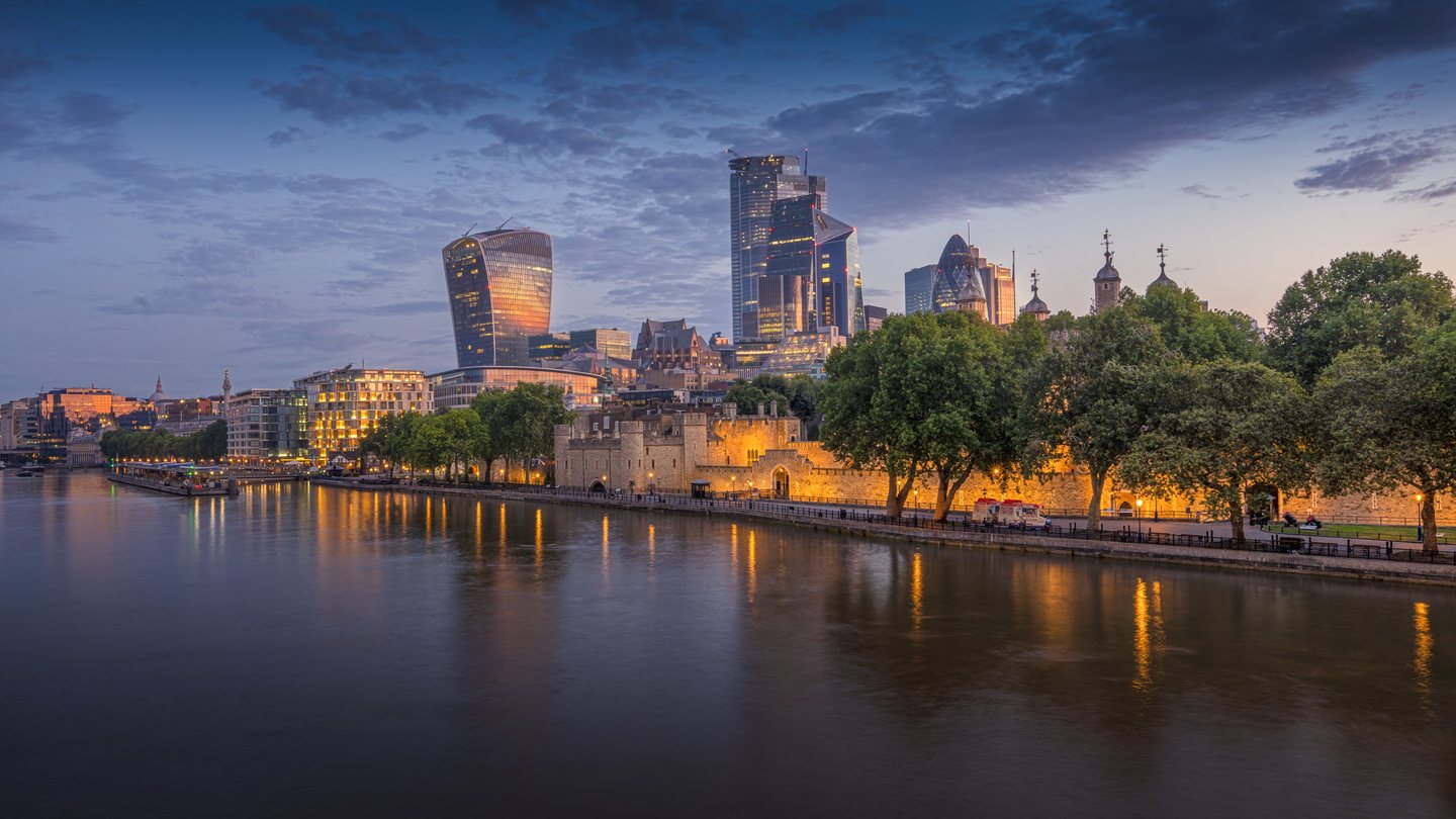 Panoramic view of London skyline along the River Thames during twilight