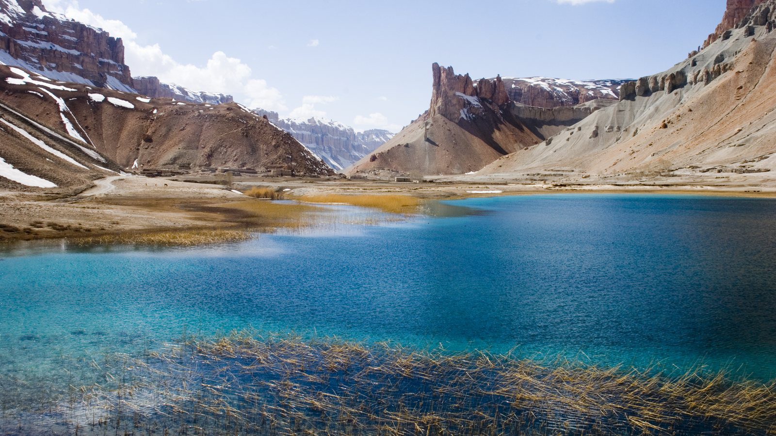 Ground-level landscape view of the mineral-rich blue lakes and travertine limestone cliffs of Band-e Amir National Park in Afghanistan