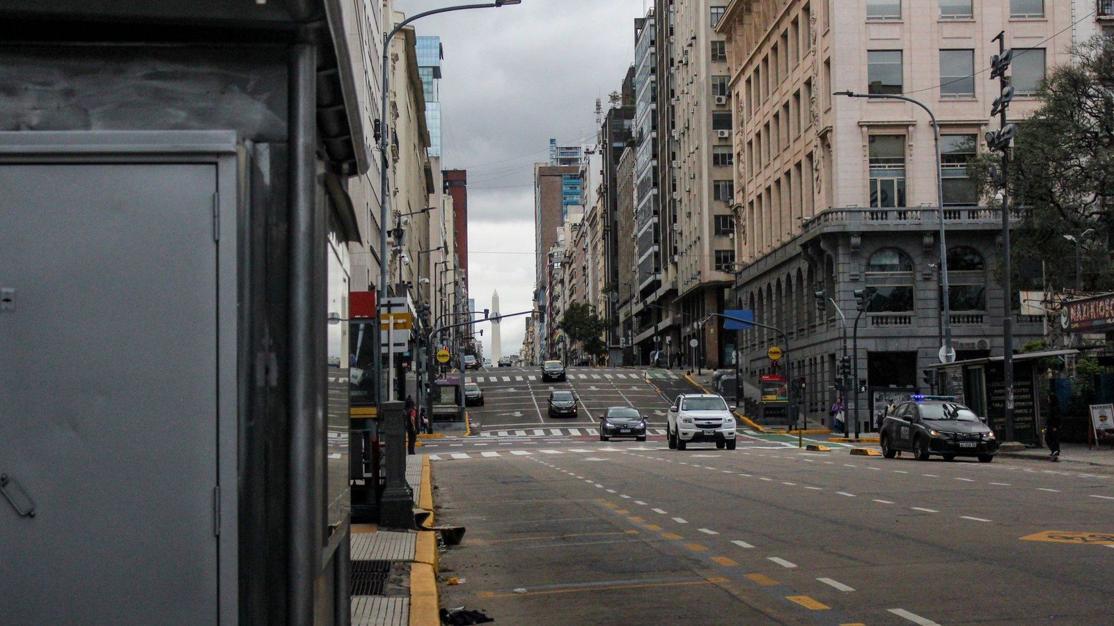 Street view of Buenos Aires showing city life with cars and buildings.