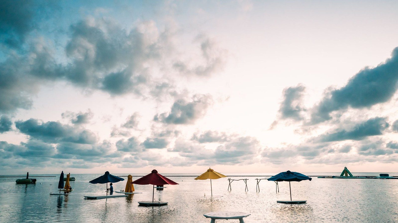 Crystal clear turquoise Caribbean waters and wooden sunbathing docks at The Split on Caye Caulker in Belize