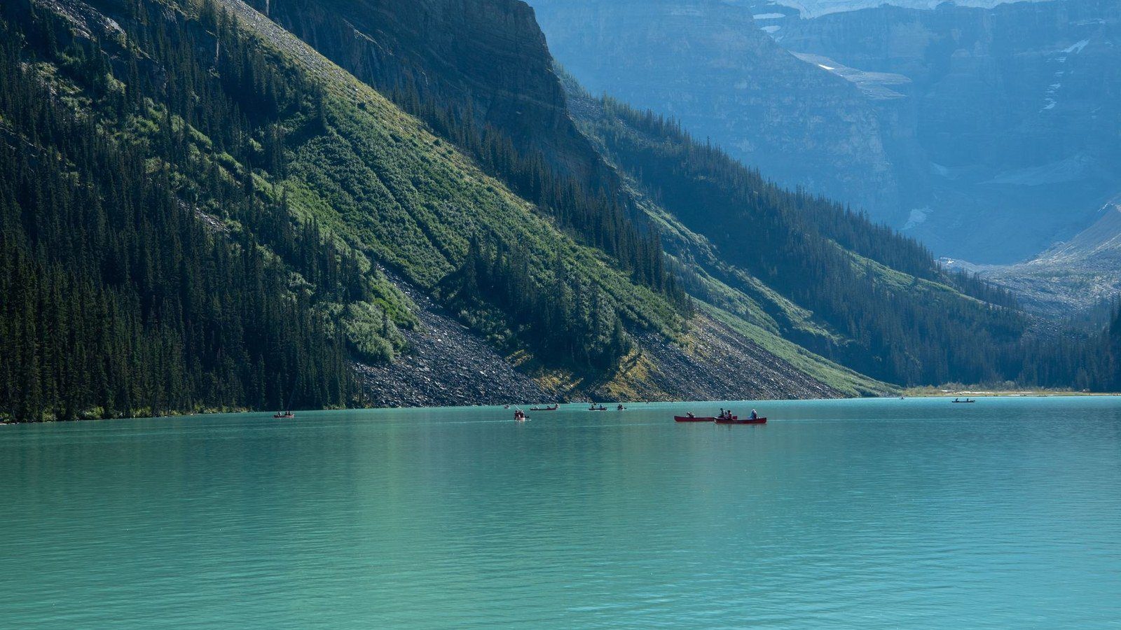 Iconic turquoise waters of Lake Louise framed by glaciated Rocky Mountain peaks