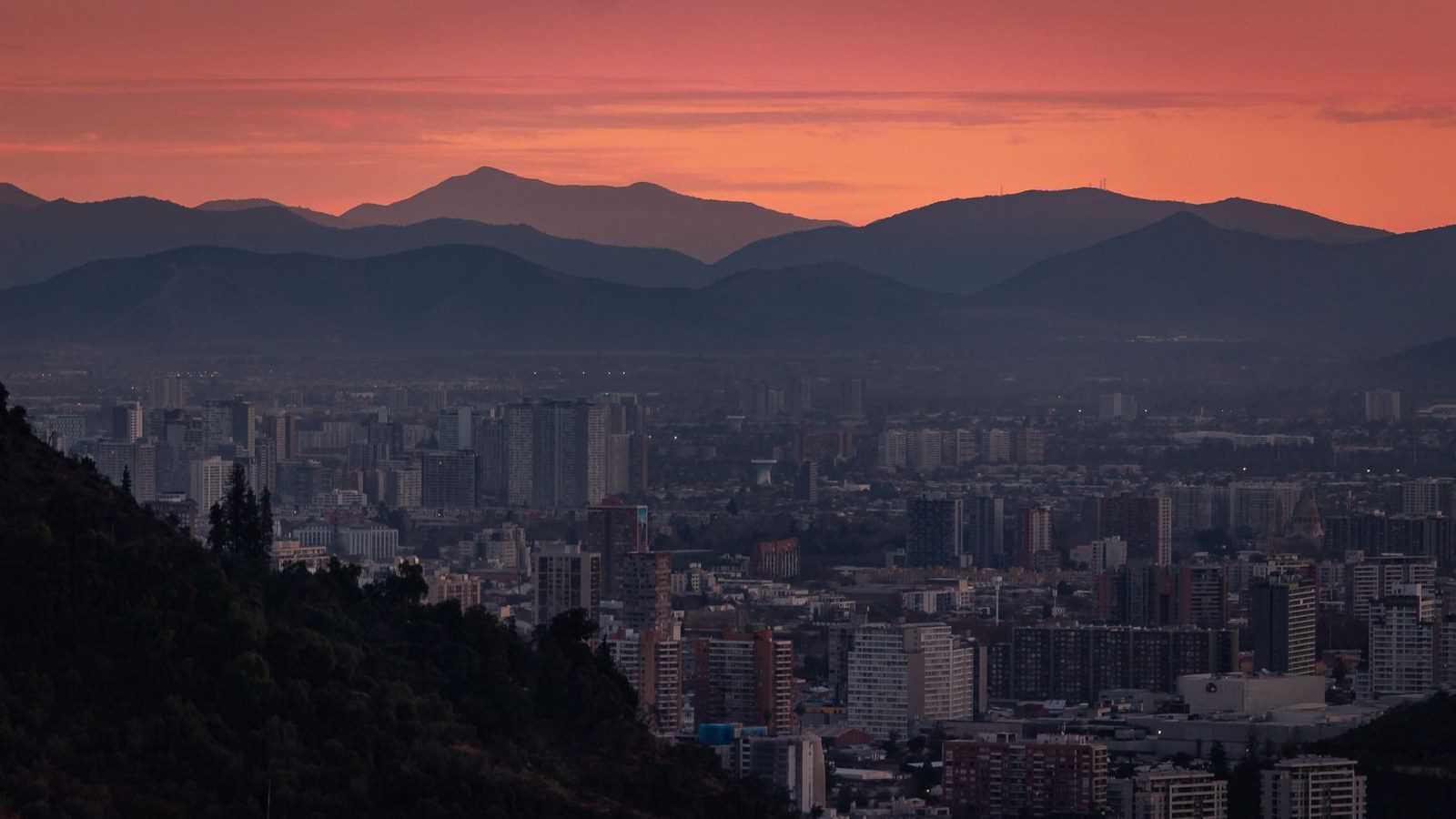 Spectacular dusk over Santiago's skyline with Andes mountains backdrop.
