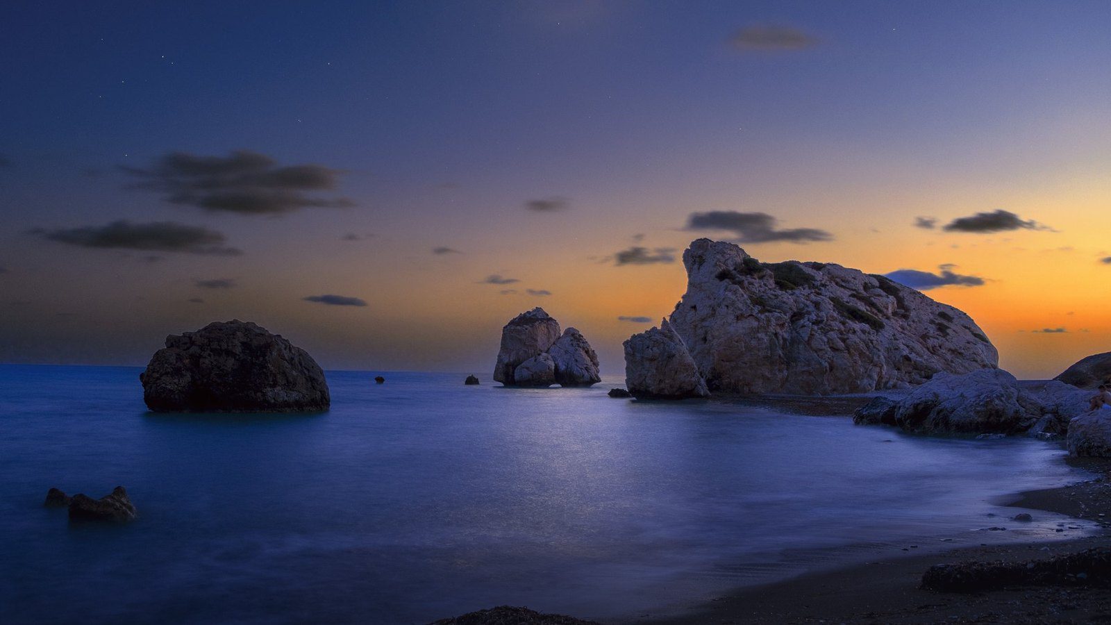Coastal sea stack of Petra tou Romiou surrounded by turquoise Mediterranean waters along the southern coastline of Cyprus