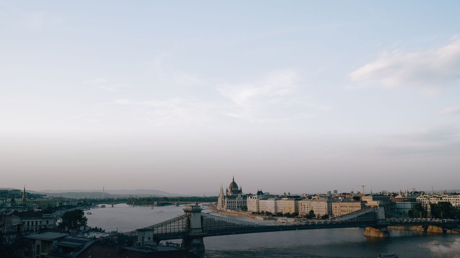 Neo-Gothic Hungarian Parliament Building along the Danube River in Budapest illuminated at sunset