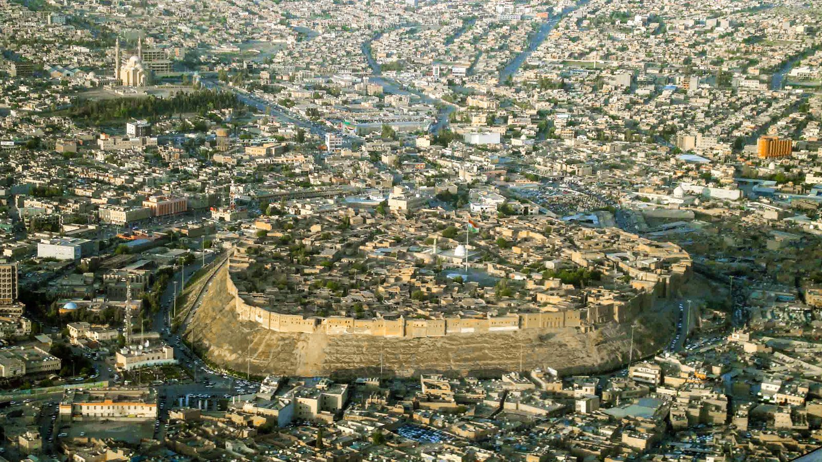Ancient fortified tell and historic brick walls of Erbil Citadel overlooking the central bazaar in Erbil, Iraq