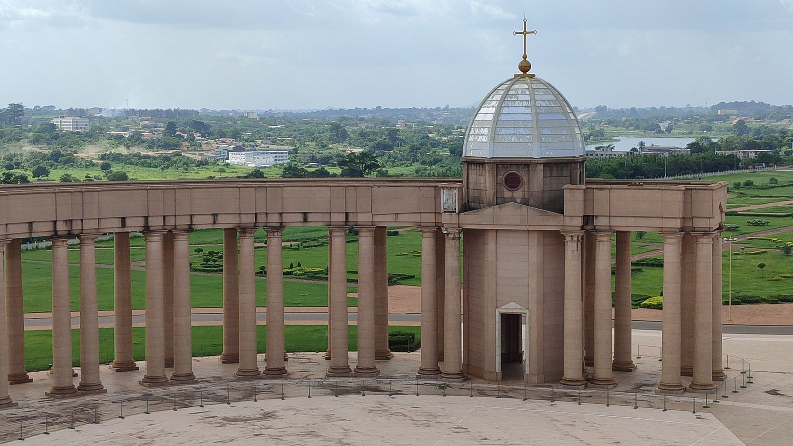 Magnificent monumental dome and colonnade of the Basilica of Our Lady of Peace rising above lush gardens in Yamoussoukro, Côte d’Ivoire