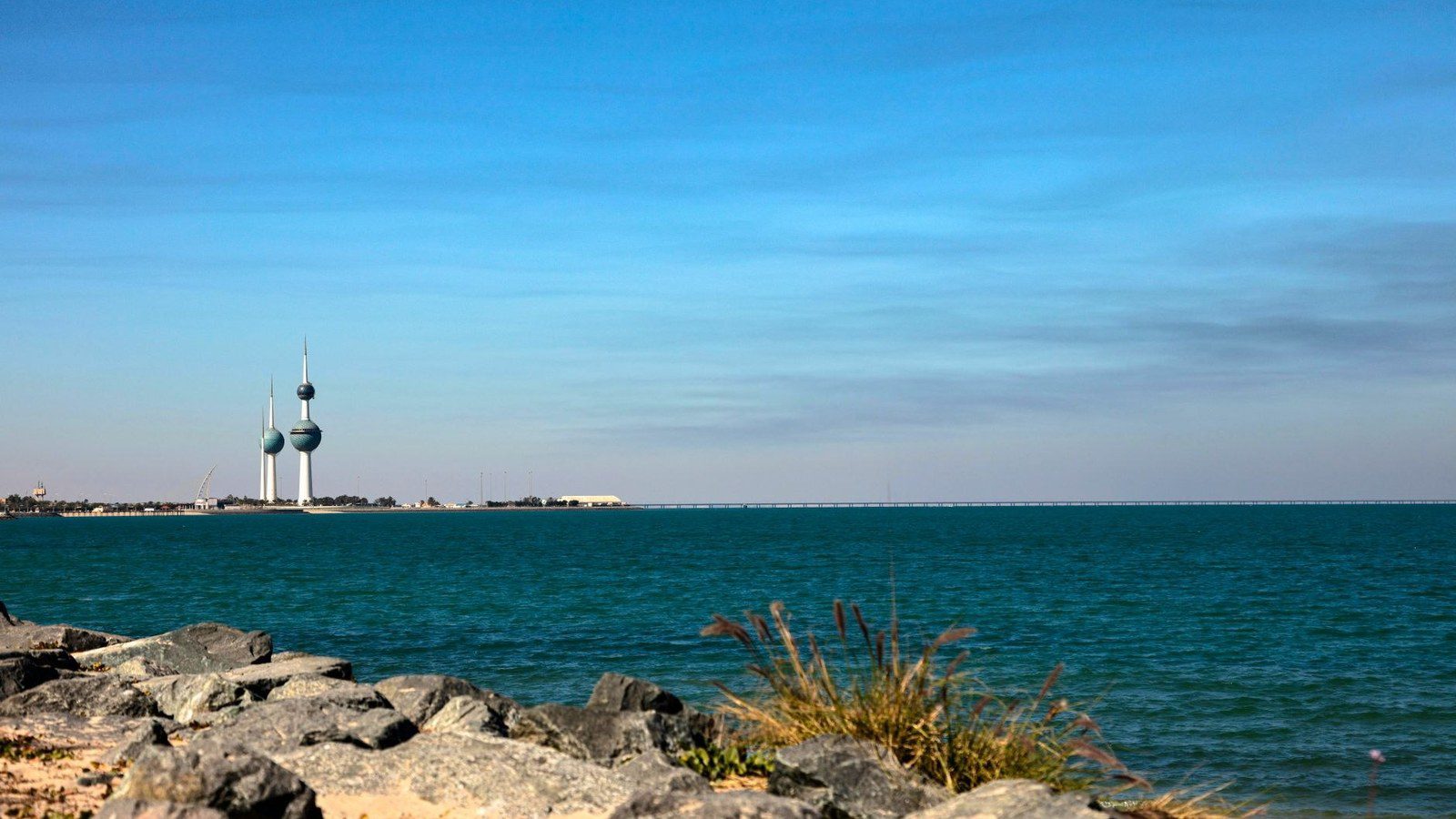 The iconic spherical Kuwait Towers rising high above the Arabian Gulf waterfront at golden sunset in Kuwait City