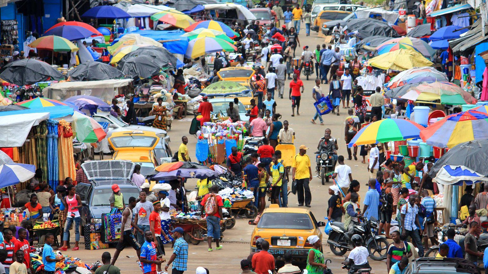 Urban streetscape of Monrovia with green palm trees and distant view of the Atlantic Ocean in Liberia