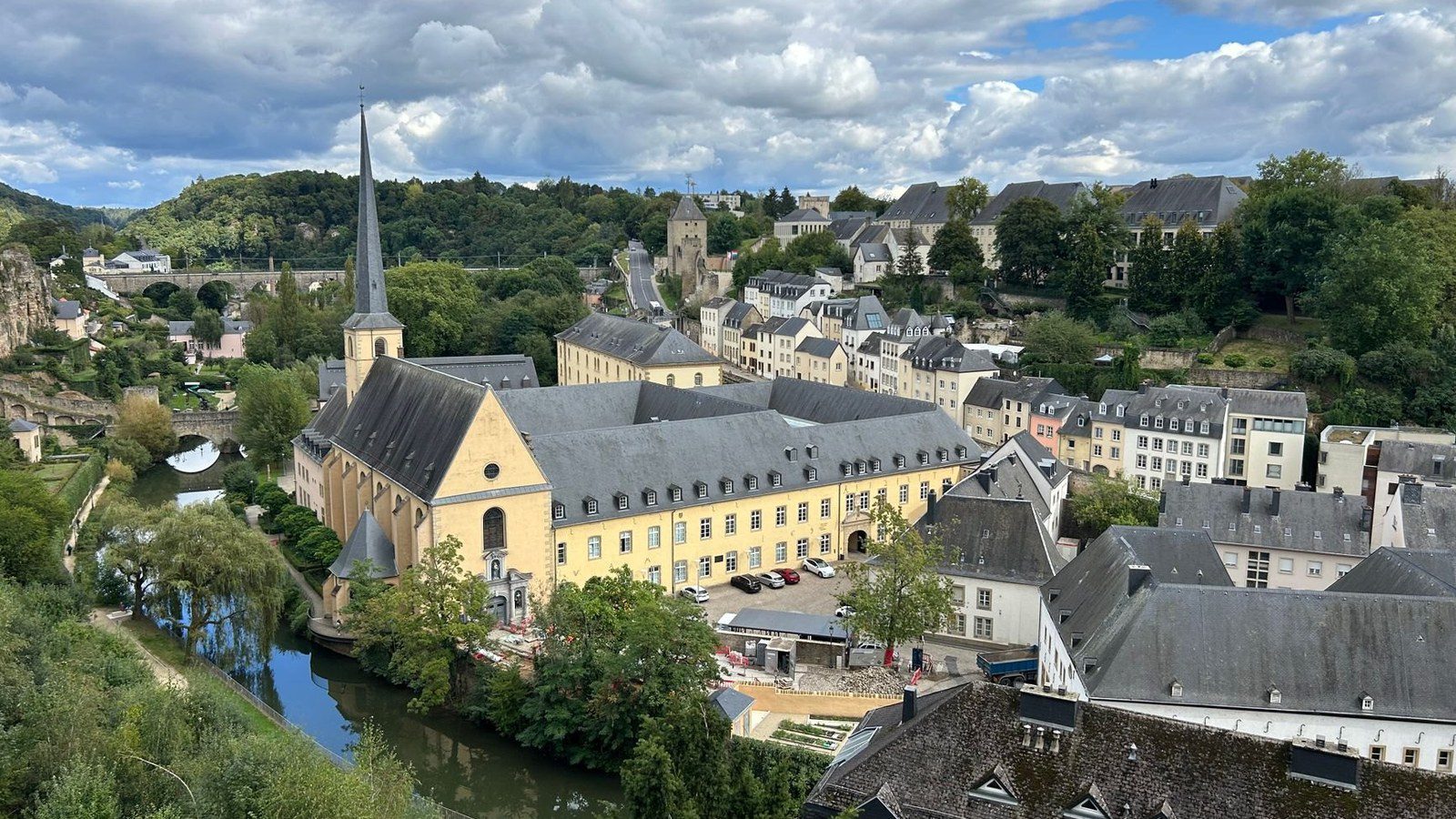 Picturesque view over the stone bridges and historic slate-roofed townhouses of the Grund valley in Luxembourg City