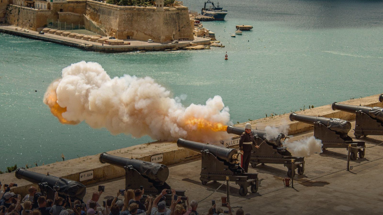 Panoramic view across Grand Harbour from Upper Barrakka Gardens in Valletta showing fortified limestone bastions