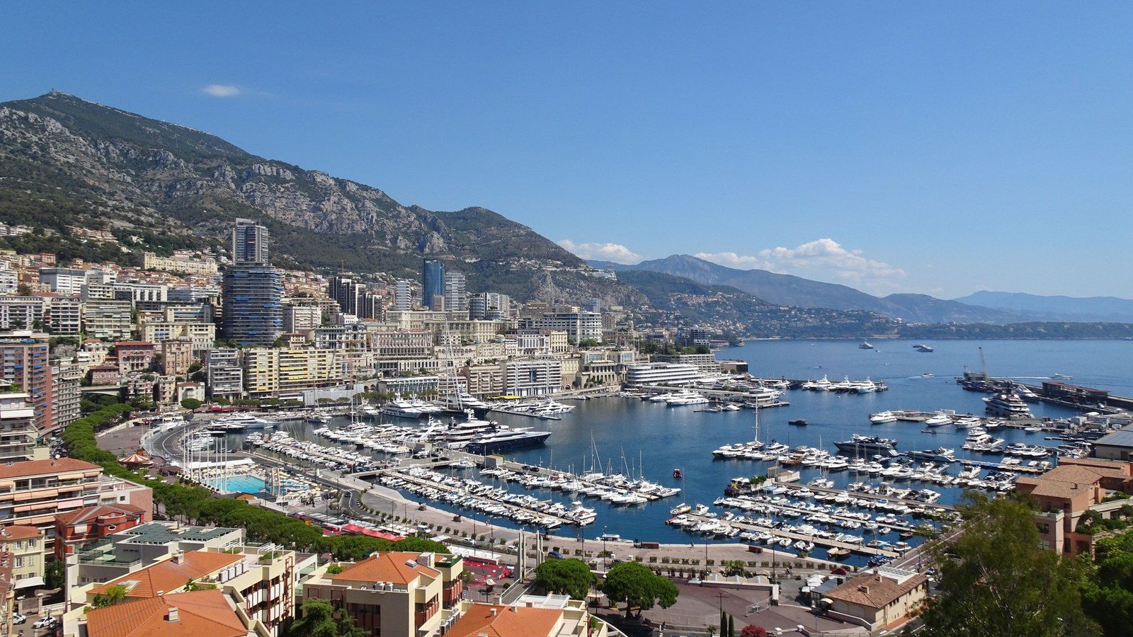 Panoramic aerial view of Port Hercule, Le Rocher, and luxury superyachts in Monaco