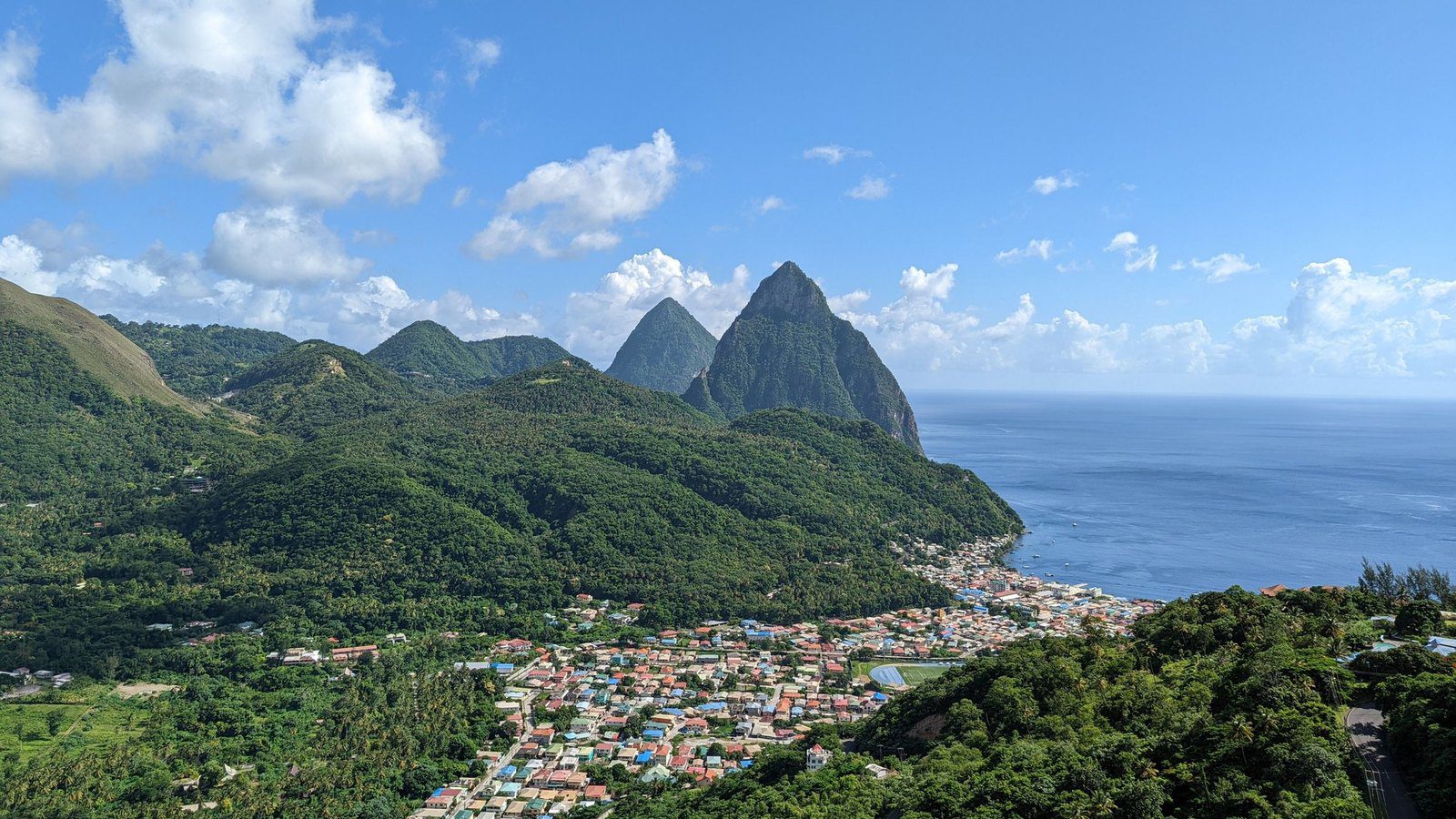 Scenic travel view of dramatic volcanic spires of the Pitons rising above Soufrière, Saint Lucia