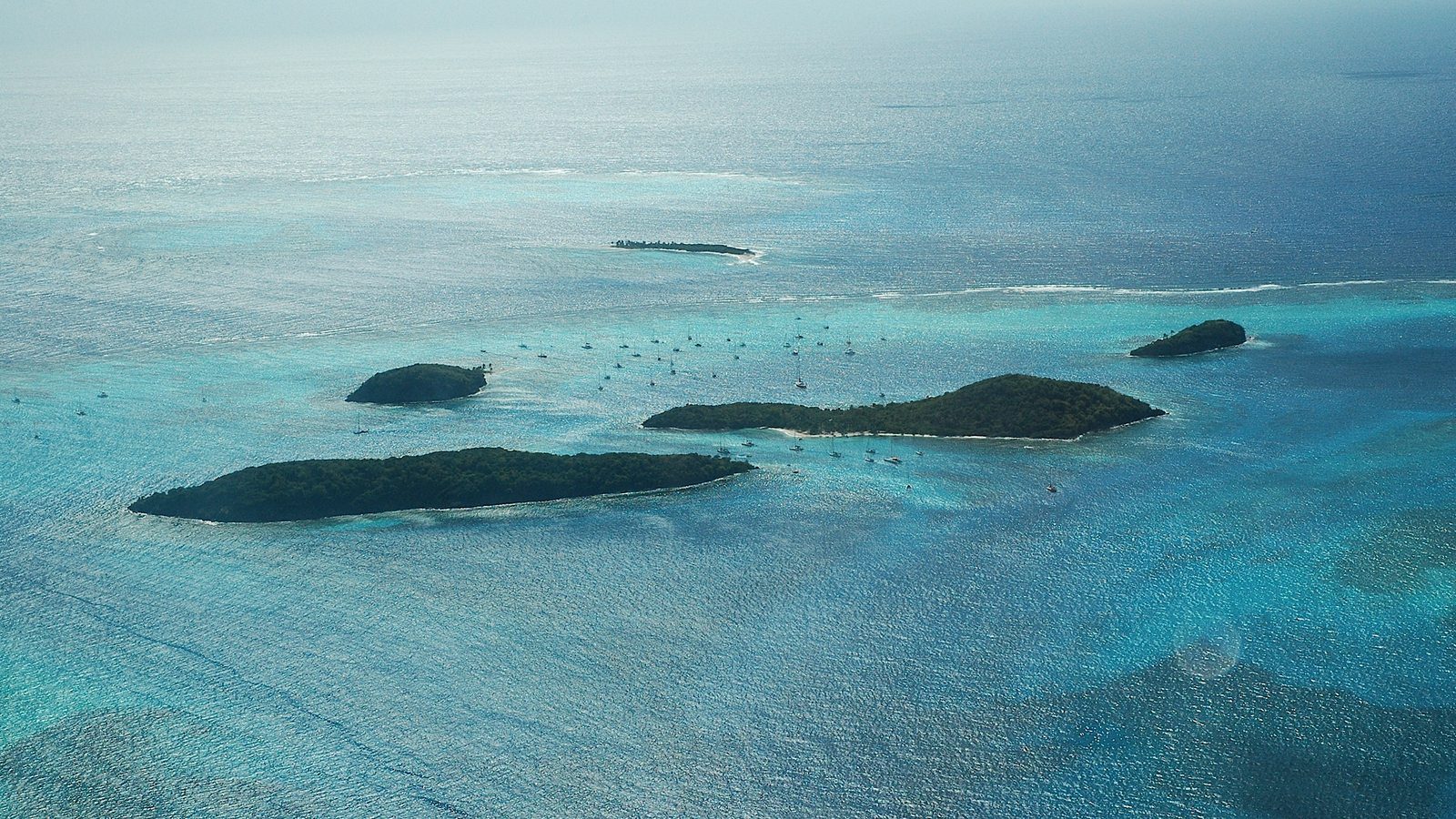 Scenic travel view of coral reefs and uninhabited cays across Tobago Cays Marine Park