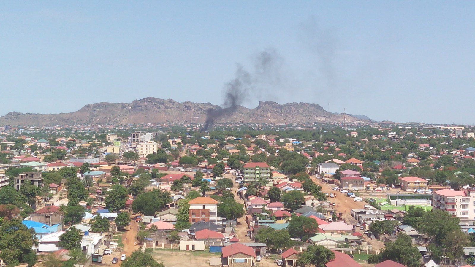 Urban streetscape and commercial buildings under cloudy sky in Juba City, South Sudan