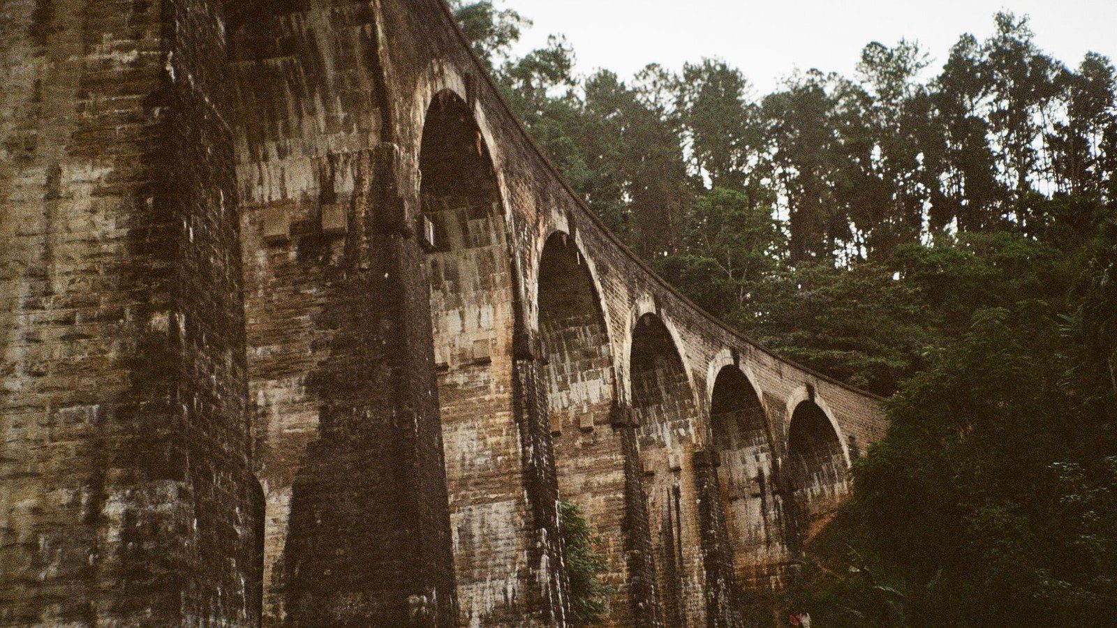 Captivating view of the historic Nine Arch Bridge surrounded by lush greenery in Sri Lanka.