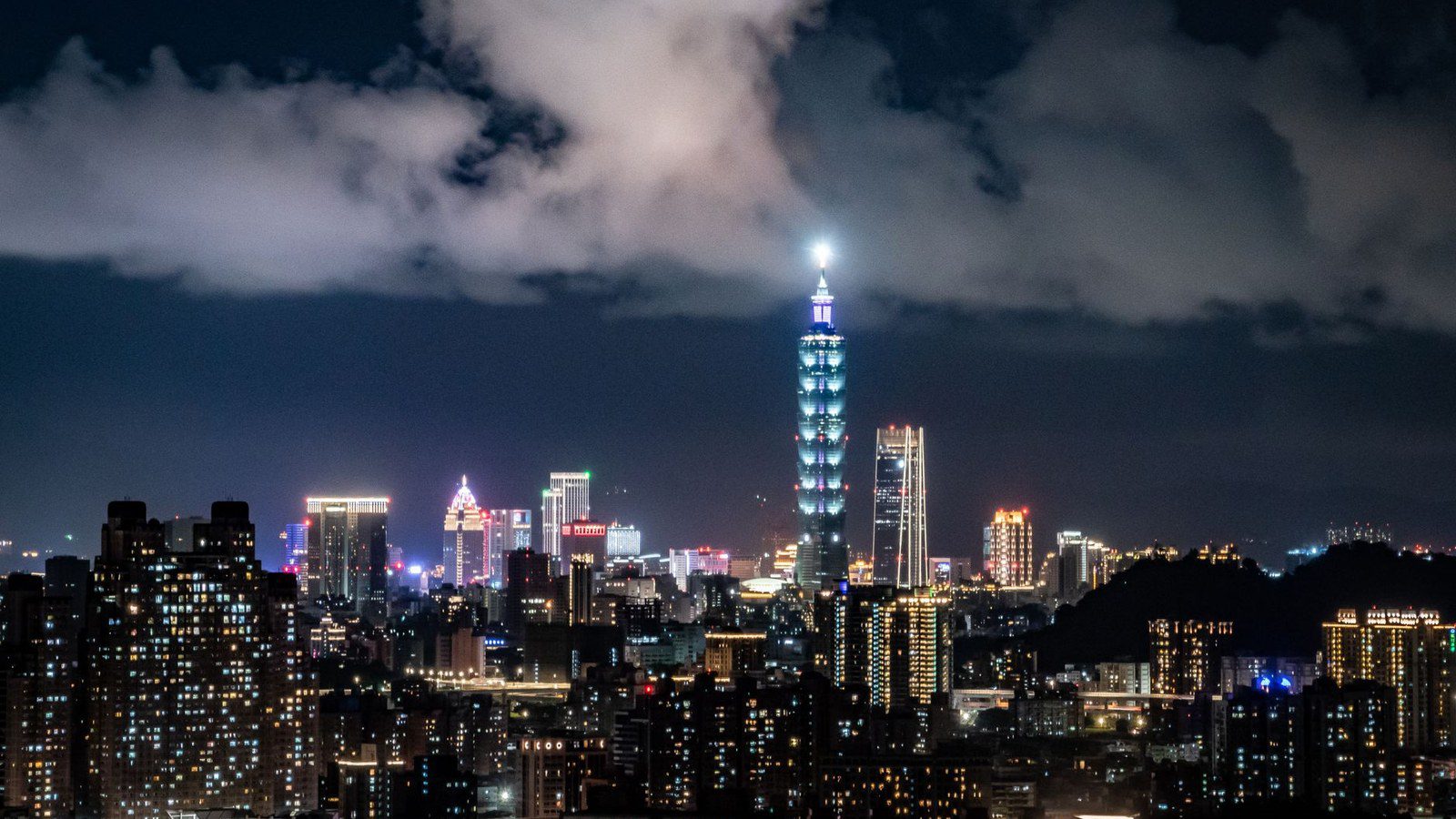 Vibrant skyline of Taipei with the iconic Taipei 101 highlighted at night.