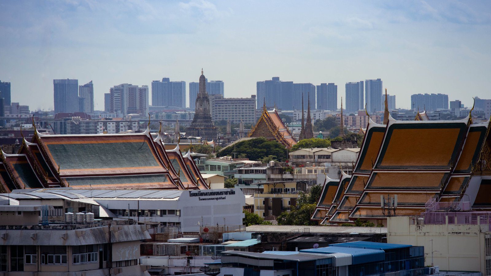 Skyline view of Bangkok highlighting traditional Thai architecture amidst modern buildings.