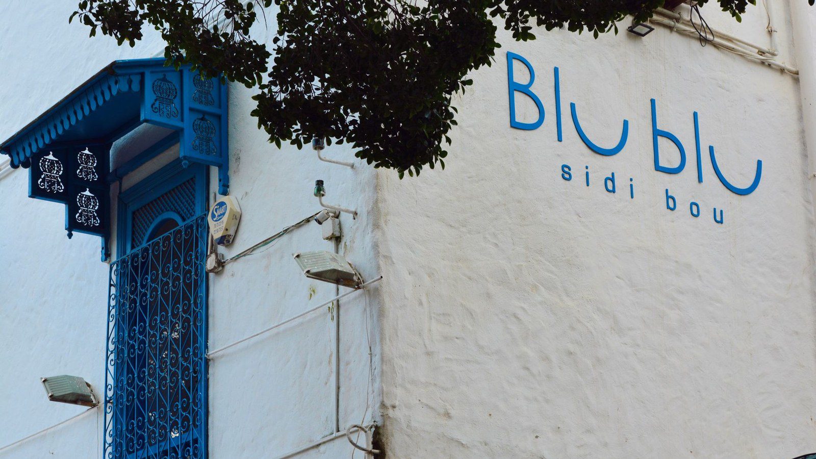 Elegant blue balcony and wall detail in Sidi Bou Said, Tunisia's iconic town.