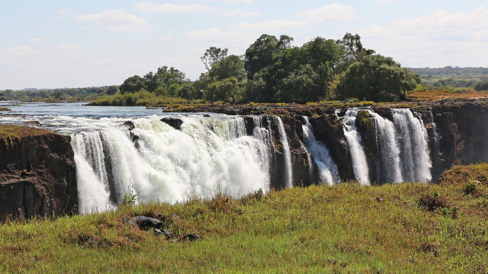 Scenic travel view of massive mist plumes rising over Victoria Falls, Zimbabwe